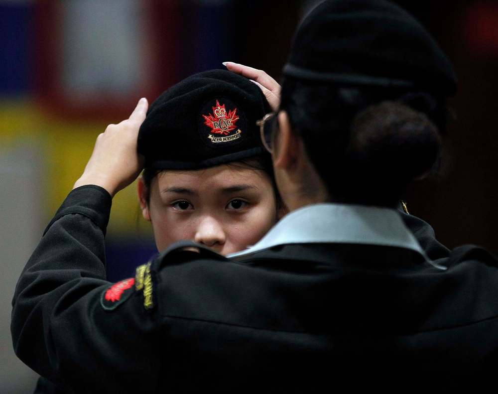 Sgt. Francisco instructs cadet Pham on how to properly wear her beret.