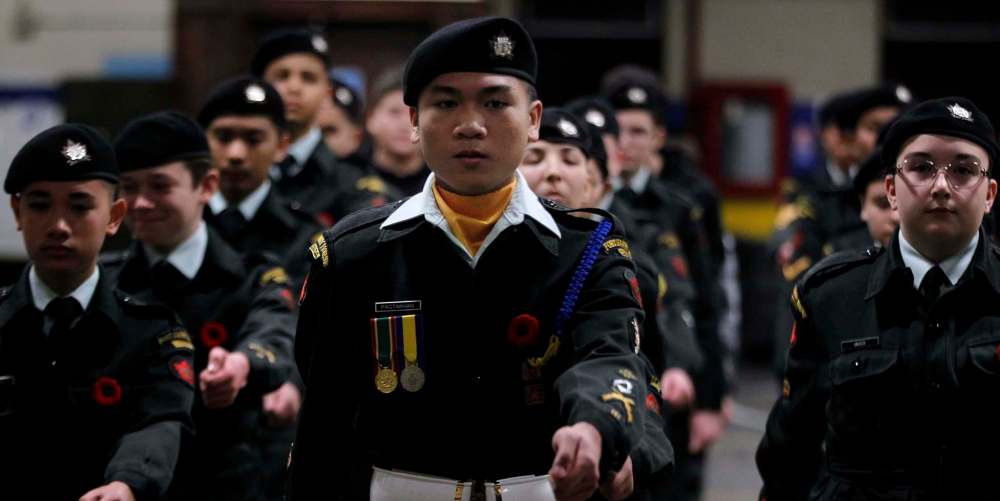 Warrant officer Pagtakhan helps members of the 1226 Fort Garry Horse Cadet Corps prepare for Remembrance Day ceremonies.