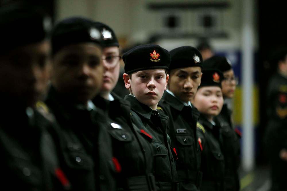 Cadet Puhach (centre) and others work on parade drills.