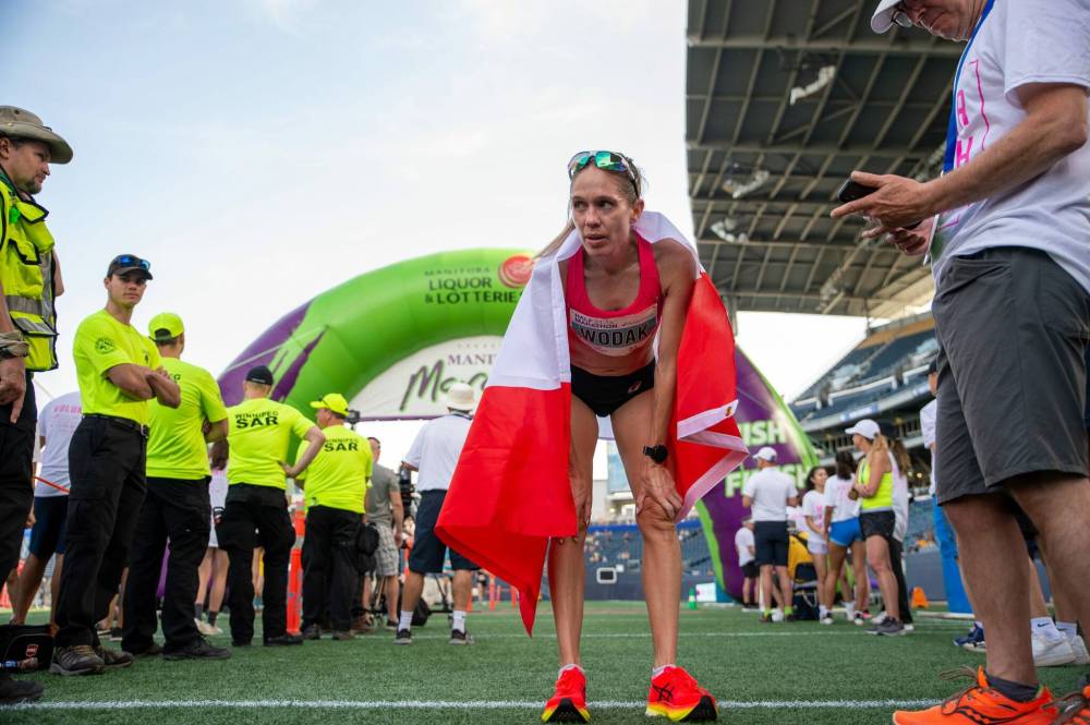 ETHAN CAIRNS / WINNIPEG FREE PRESS
Natasha Wodak arrives at the finish line in IG Field fo win the Half-Marathon race part of the Manitoba Marathon, which was cancelled due to extreme heat.