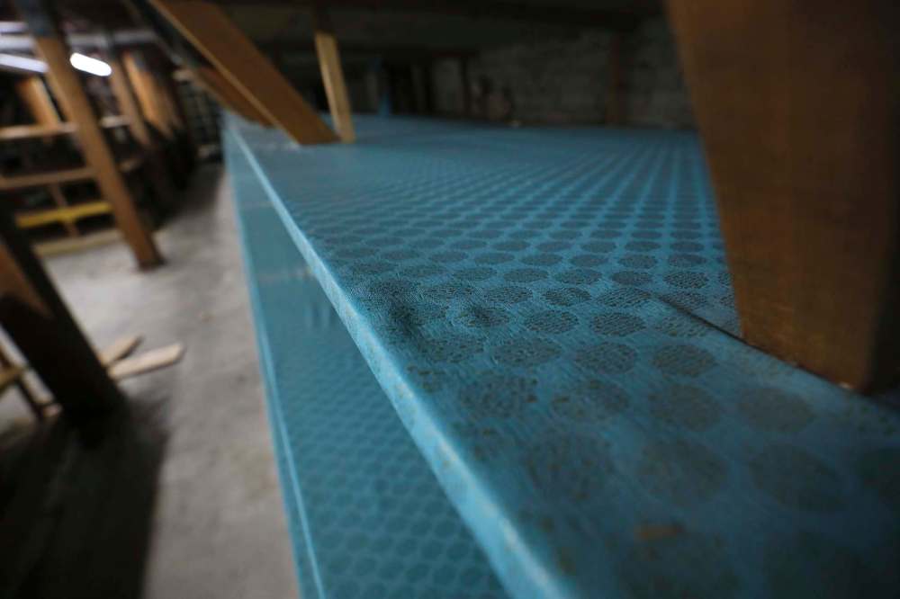 Shelving units in the basement area that once held reams of fabric now lay bare. The store often covered the wooden shelves with fabric or wallpaper.
