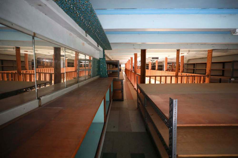 Floor-to-ceiling shelving units once held reams of fabric.