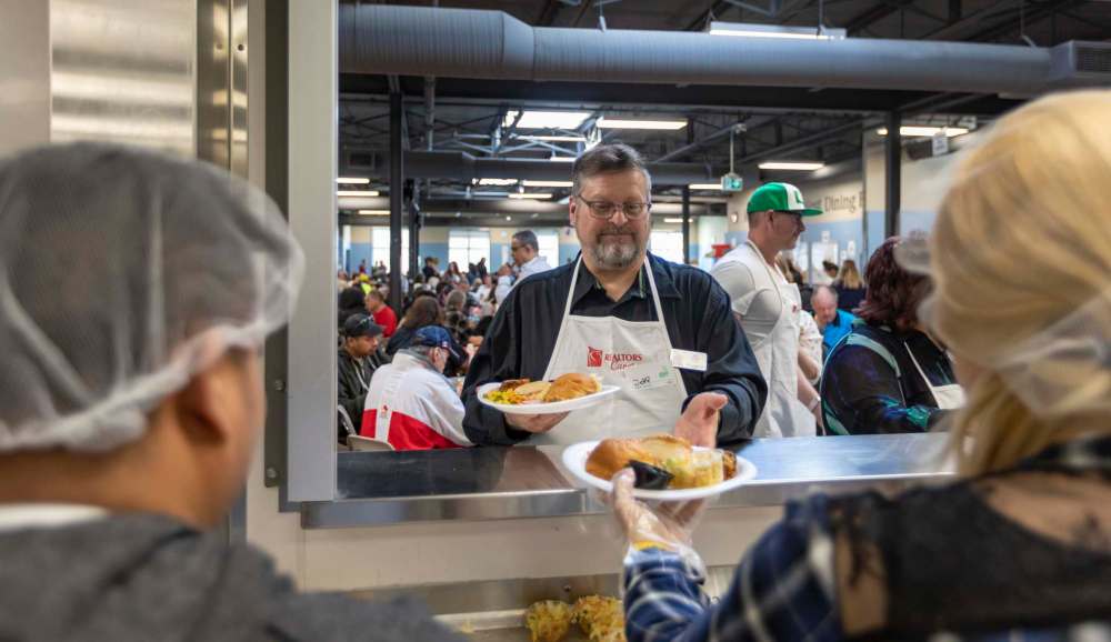 Shelter Foundation chair Jeff Stern helps with service at Siloam Mission’s annual Easter meal on Monday.