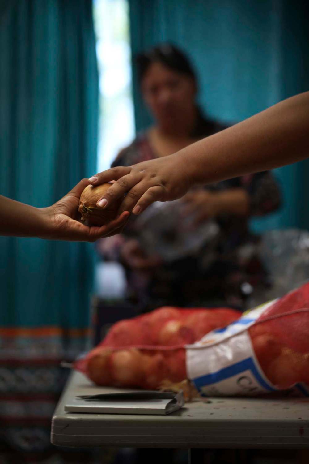 Volunteers unpack food to be loaded into crates.