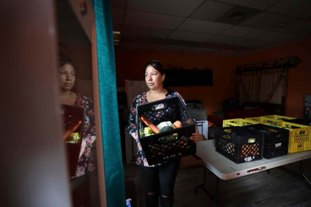 Melissa McDonald takes a moment to look over the crate of fresh food she portioned out for customers at the Indigenous Family Centre’s market.