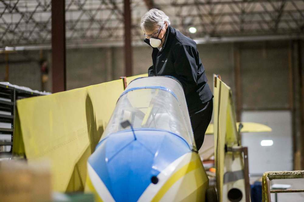 Frank Roberts, consulting engineer, measures out a Schweizer Glider, one of the seven aircraft that will hang from the roof in the new facility.