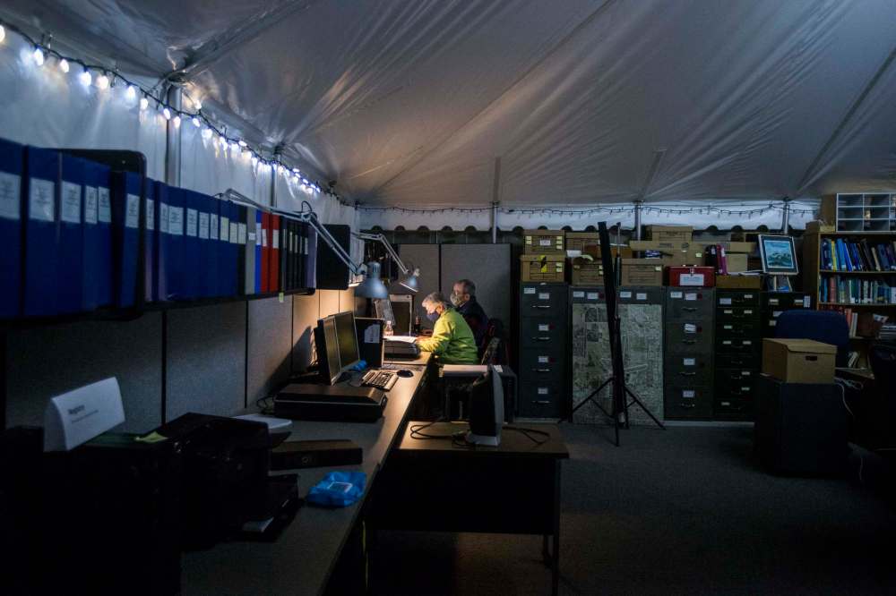 Married couple Lorraine Iverach and Bill Brereton look through the archives for photos to use in displays.
