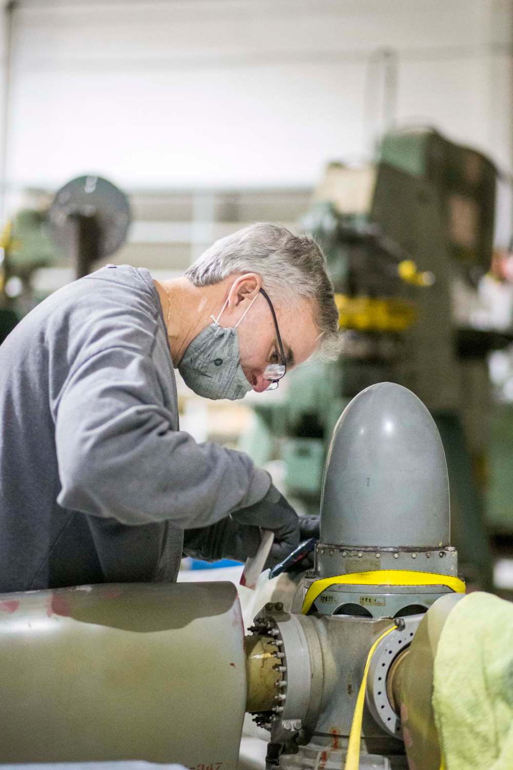 Matt Halpin works on restoring a propeller.