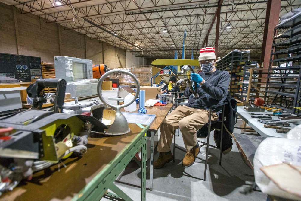 Long-time volunteer Gordon Stewart cleans pieces for an interactive children's display.
