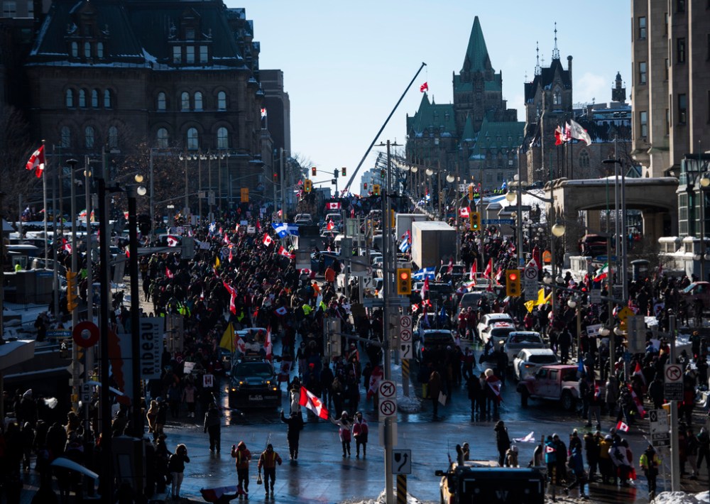 People and vehicles fill Wellington Street near Parliament Hill during a rally against COVID-19 restrictions, which began as a cross-country convoy protesting a federal vaccine mandate for truckers, in Ottawa, on Saturday, Jan. 29, 2022. (JUSTIN TANG / THE CANADIAN PRESS)
