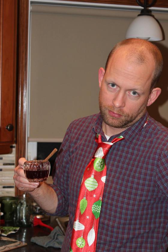 SUPPLIED Decked out in a festive tie, glass of mulled wine in hand and looking positively thrilled about it all.