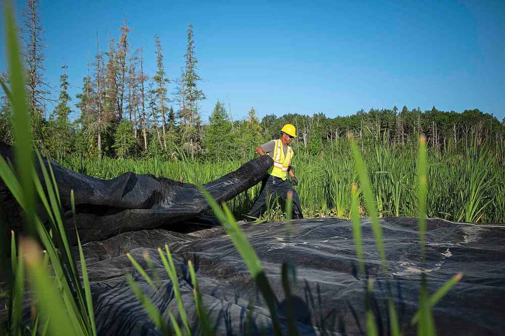 ANDREW RYAN / WINNIPEG FREE PRESS
Jim Sinclair hauls geotextile fabric over the land which is to become Freedom Road.