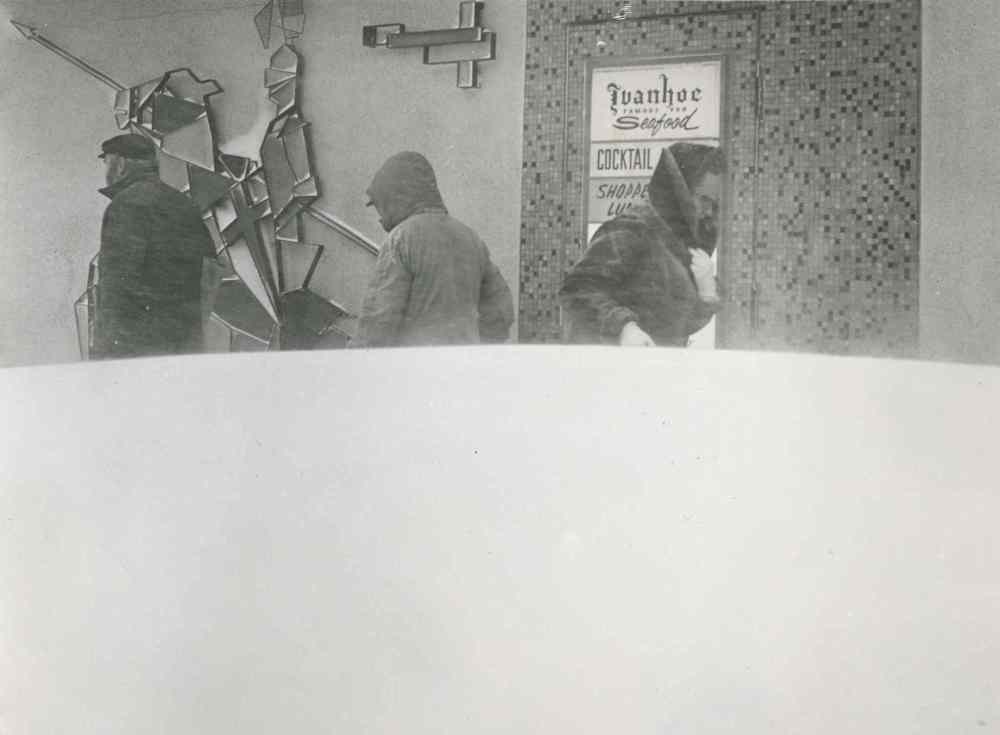 Pedestrians are half hidden by a waist-high snowdrift. (Jack Ablett / Winnipeg Free Press Archives)