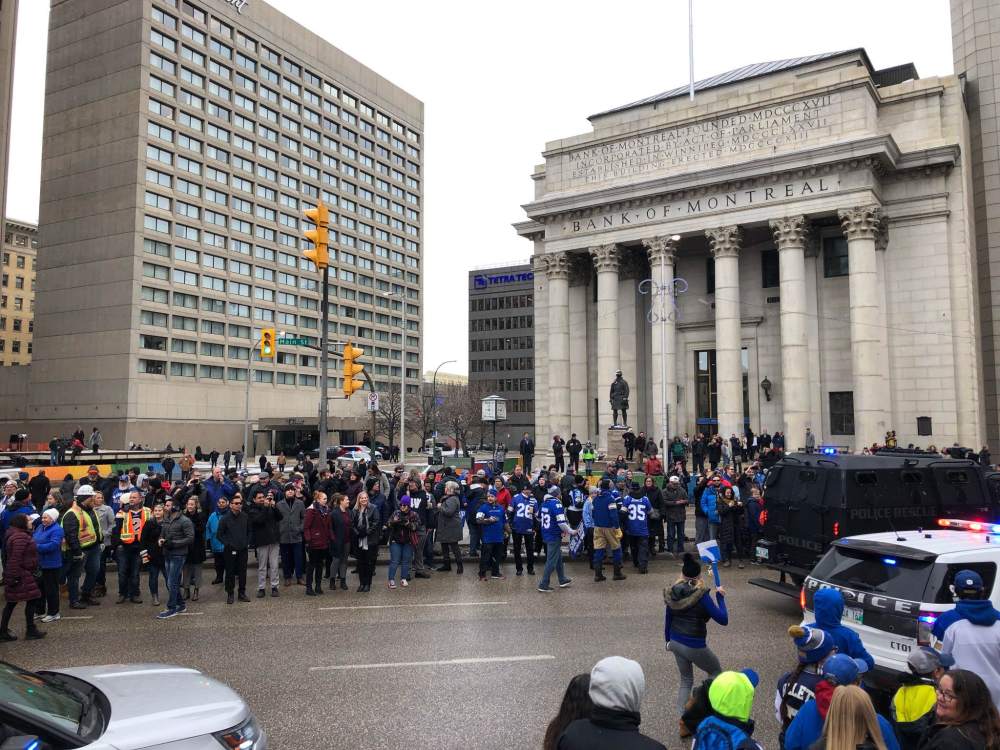The parade moves through Portage and Main. (Danielle DaSilva / Winnipeg Free Press)