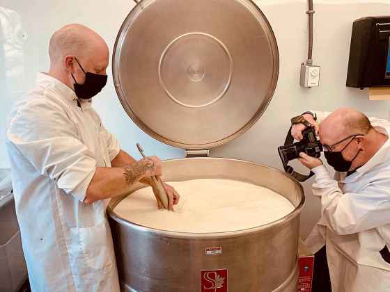 Free Press photographer Mike Deal gets an action shot of Loaf and Honey co-owner Dustin Peltier stirring curds to make Golden Prairie Trappist-style cheese at the facility near Warren, Man. (Jill Wilson / Winnipeg Free Press)