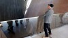 Canadian Museum for Human Rights architect Antoine Predock gets tour of the museum he designed , in picture Predock inspects baslt rock wall seen    from  second level  walkway ascending throughout the museum ,  May 29 2014 / KEN GIGLIOTTI / WINNIPEG FREE PRESS