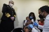 Pediatrician Emy Jean-Marie, center, holds her nine-month-old son Adedeji Adebayo, Emiola Adebayo, 3, on her lap as Dr. Nizar Dowla, right, administers a vaccine while        Department of Health and Human Services Assistant Secretary for Health, Admiral Rachel Levine, left, looks on, Tuesday, June 28, 2022, at the Borinquen Health Care Center in Miami. Florida is the only state that didn't pre-order the under-5 vaccine, and state Surgeon General Joseph Ladapo has recommended against vaccinating healthy children. (AP Photo/Wilfredo Lee)