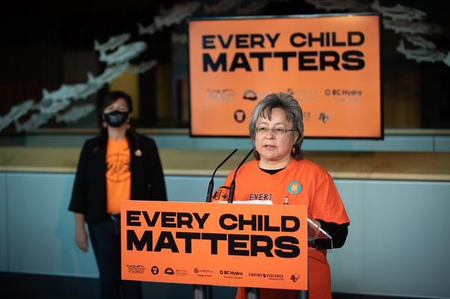 Residential school survivor Phyllis Webstad, founder of Orange Shirt Day, speaks as Tk’emlúps te Secwépemc Kúkpi7 (Chief) Rosanne Casimir listens, on Thursday, Sept. 16, 2021. Manitoba could have a new statutory holiday to mark the National Day for Truth and Reconciliation by September, Premier Heather Stefanson says. The day — also known as Orange Shirt Day — was established in honour of the experience of Phyllis Webstad, whose gift of clothing from her grandmother was taken away on Webstad's first day at a residential school. THE CANADIAN PRESS/Darryl Dyck