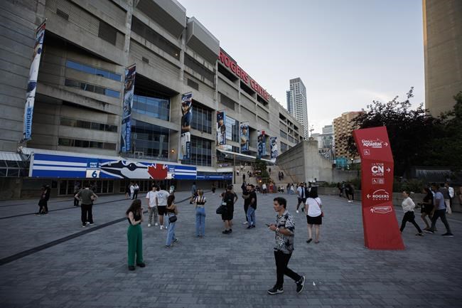 Fans outside the Rogers Centre after The Weeknd's Toronto show is postponed, amid telecommunication company Rogers' service trouble, Friday, July 8, 2022. THE CANADIAN PRESS/Cole Burston