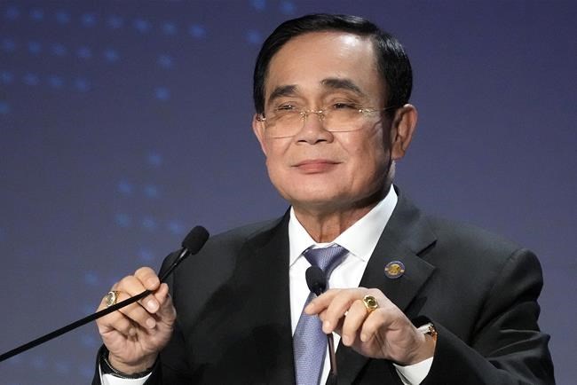FILE - Thailand's Prime Minister Prayuth Chan-ocha adjusts microphones to deliver a speech at a session of the International Conference on