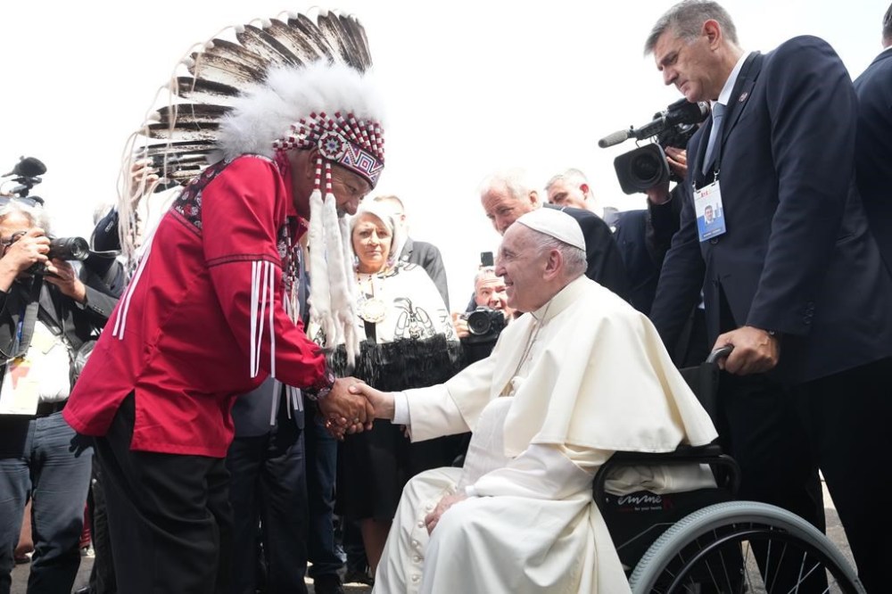 Pope Francis is greeted by George Arcand, Grand Chief of the Confederacy of Treaty Six First Nations, as he arrives in Edmonton on Sunday, July 24, 2022. His visit to Canada is aimed at reconciliation with Indigenous people for the Catholic Church's role in residential schools.THE CANADIAN PRESS/Nathan Denette