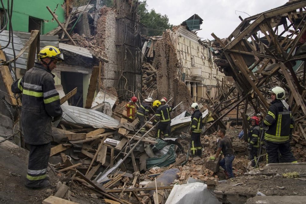 Rescuers remove debris following a Russian missile attack in Chuhuiv, Kharkiv region, Ukraine, Monday, July 25, 2022. (AP Photo/Evgeniy Maloletka)