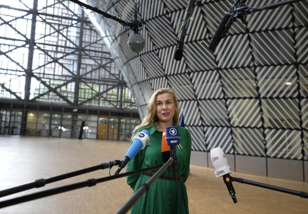European Commissioner for Energy Kadri Simson speaks with the media as she arrives for an emergency meeting of EU energy ministers in Brussels on Tuesday, July 26, 2022. European Union governments Tuesday neared an agreement on rationing natural gas this winter to protect against any further supply cuts by Russia. (AP Photo/Virginia Mayo)