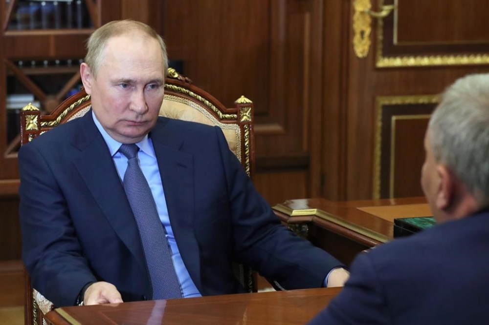 Russian President Vladimir Putin listens to Yuri Borisov, the new CEO of the Russian State Space Corporation