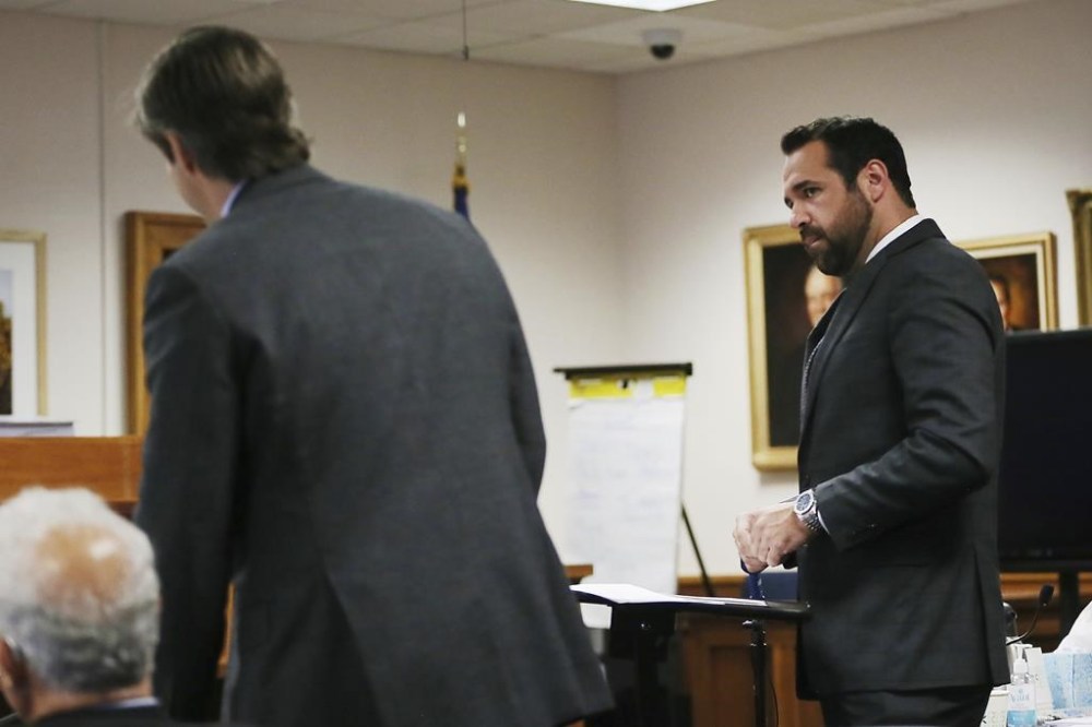 Bill Ogden, right, lawyer representing Neil Heslin and Scarlett Lewis, looks at Andino Reynal, lawyer for Alex Jones, during the fifth day of trial at the Travis County Courthouse in Austin, Texas, Monday, Aug. 1, 2022. Jones has been found to have defamed the parents of a Sandy Hook student for calling the attack a hoax. (Briana Sanchez/Austin American-Statesman via AP)