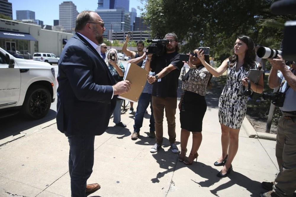 Alex Jones arrives at the Travis County Courthouse in Austin, Tuesday Aug. 2, 2022. The father of a 6-year-old killed in the Sandy Hook Elementary School shooting has testified that conspiracy theorist Alex Jones made his life a “living hell” by pushing claims the murders were a hoax. Neil Heslin testified Tuesday that he fears for his life because of Jones' claims. Heslin and Scarlett Lewis are the parents of 6-year-old Jesse Lewis. (Briana Sanchez/Austin American-Statesman via AP)