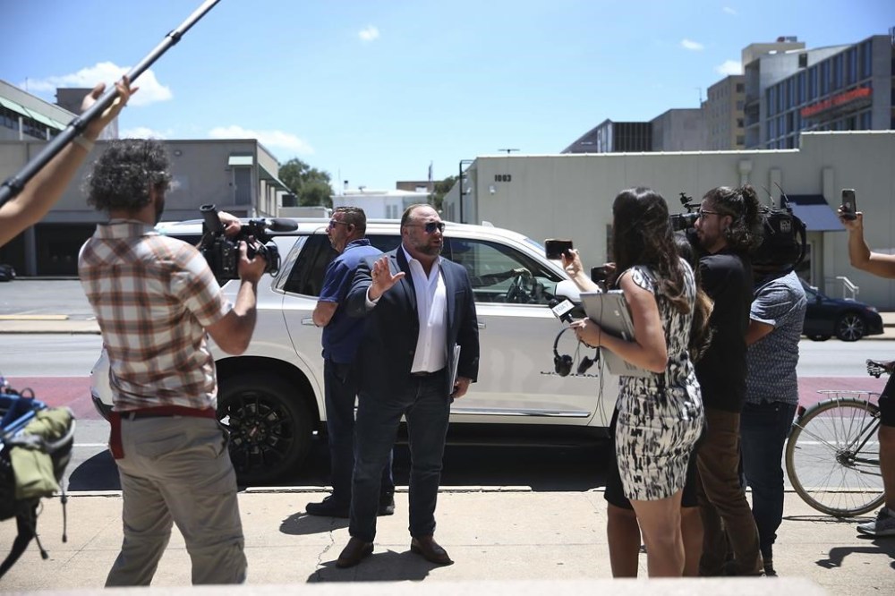 Alex Jones arrives at the Travis County Courthouse in Austin, Tuesday Aug. 2, 2022. The father of a 6-year-old killed in the Sandy Hook Elementary School shooting has testified that conspiracy theorist Alex Jones made his life a “living hell” by pushing claims the murders were a hoax. Neil Heslin testified Tuesday that he fears for his life because of Jones' claims. Heslin and Scarlett Lewis are the parents of 6-year-old Jesse Lewis. (Briana Sanchez/Austin American-Statesman via AP)