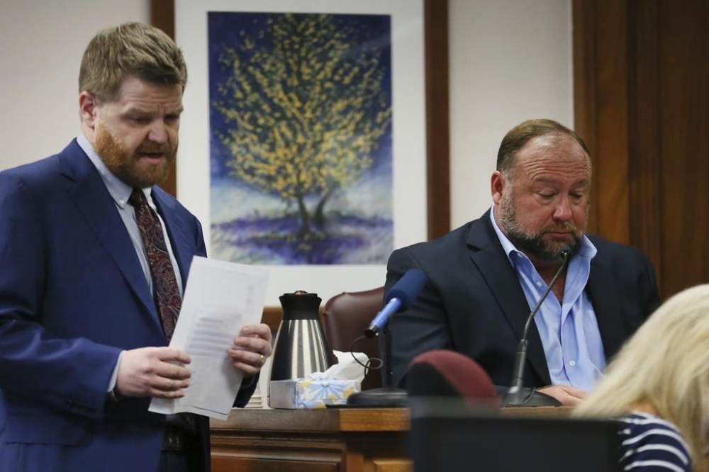 Mark Bankston, lawyer for Neil Heslin and Scarlett Lewis, asks Alex Jones questions about text messages during trial at the Travis County Courthouse in Austin, Wednesday Aug. 3, 2022. Jones testified Wednesday that he now understands it was irresponsible of him to declare the Sandy Hook Elementary School massacre a hoax and that he now believes it was “100% real.