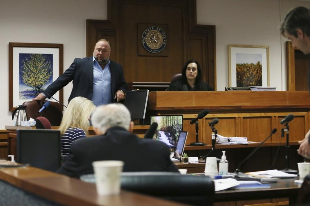 Alex Jones takes a seat to testify in court at t the Travis County Courthouse, Wednesday Aug. 3, 2022, in Austin, Texas. (Briana Sanchez/Austin American-Statesman via AP)