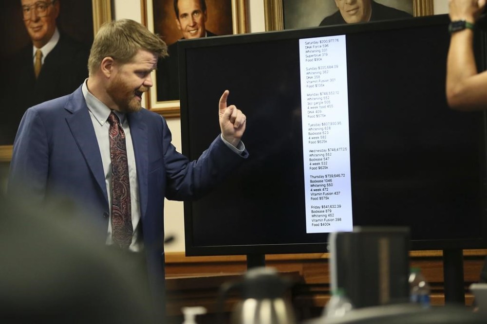 Mark Bankston, lawyer for Neil Heslin and Scarlett Lewis, asks Alex Jones about the profits he makes a day during a trial at the Travis County Courthouse, Wednesday Aug. 3, 2022, in Austin, Texas. (Briana Sanchez/Austin American-Statesman via AP)