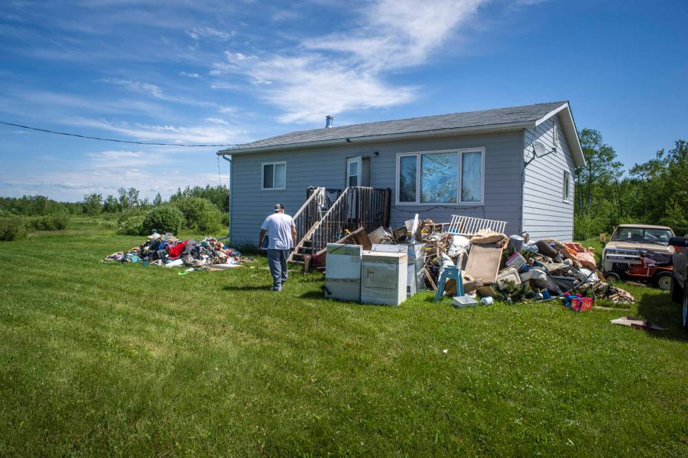 AARON VINCENT ELKAIM / THE NARWHAL
Community cleanup worker Trevor McPherson walks into a flooded out home of Len Kipling.