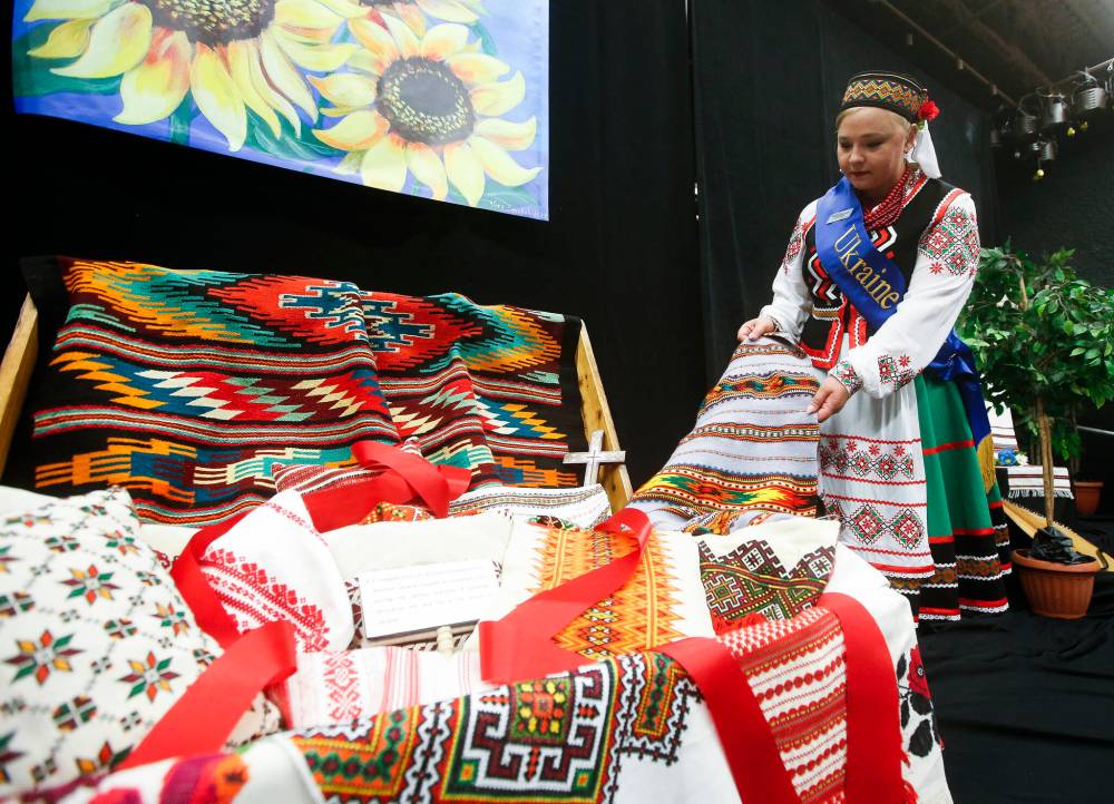Ambassador Samantha Luczenczyn-Lane looks at some traditional weaving. (John Woods / Winnipeg Free Press)