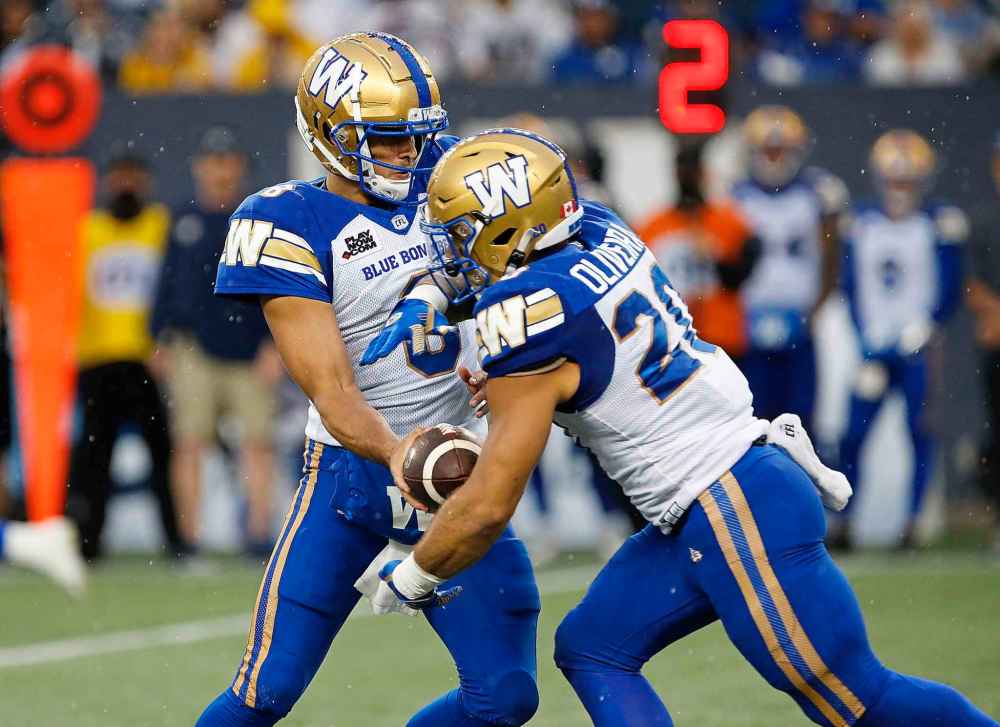 THE CANADIAN PRESS
Winnipeg Blue Bombers quarterback Zach Collaros hands off to Brady Oliveira who finished with 15 carries for 56 yards for a 3.6 yards per carry average. (John Woods / The Canadian Press files)