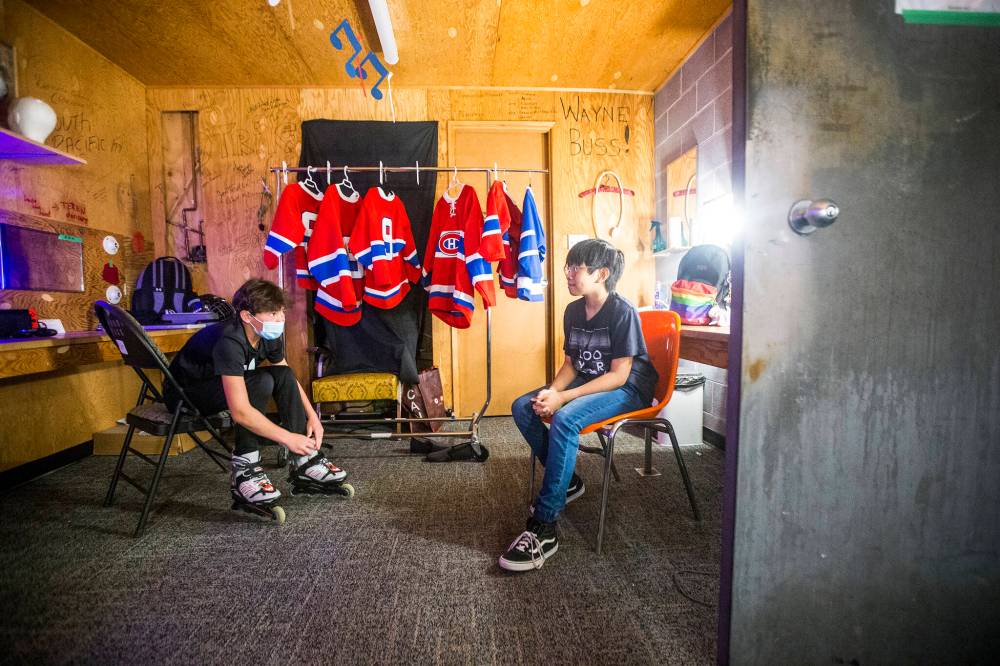 Erik Evason, left, who plays Olivier Gélineau, and Malolos in the dressing room backstage at Rainbow Stage.