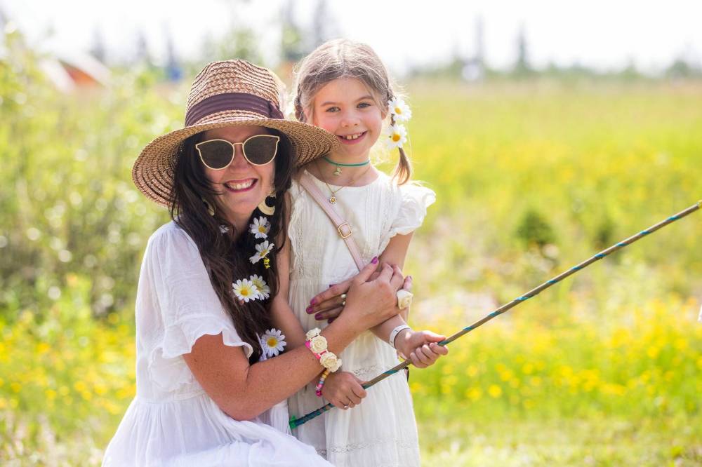 Photos by MIKAELA MACKENZIE / WINNIPEG FREE PRESS
Jessi Madill and Lowen, 7, in cotton dresses with flowers in their hair. Madill says she checked her closet ‘to see what we have that matches.’