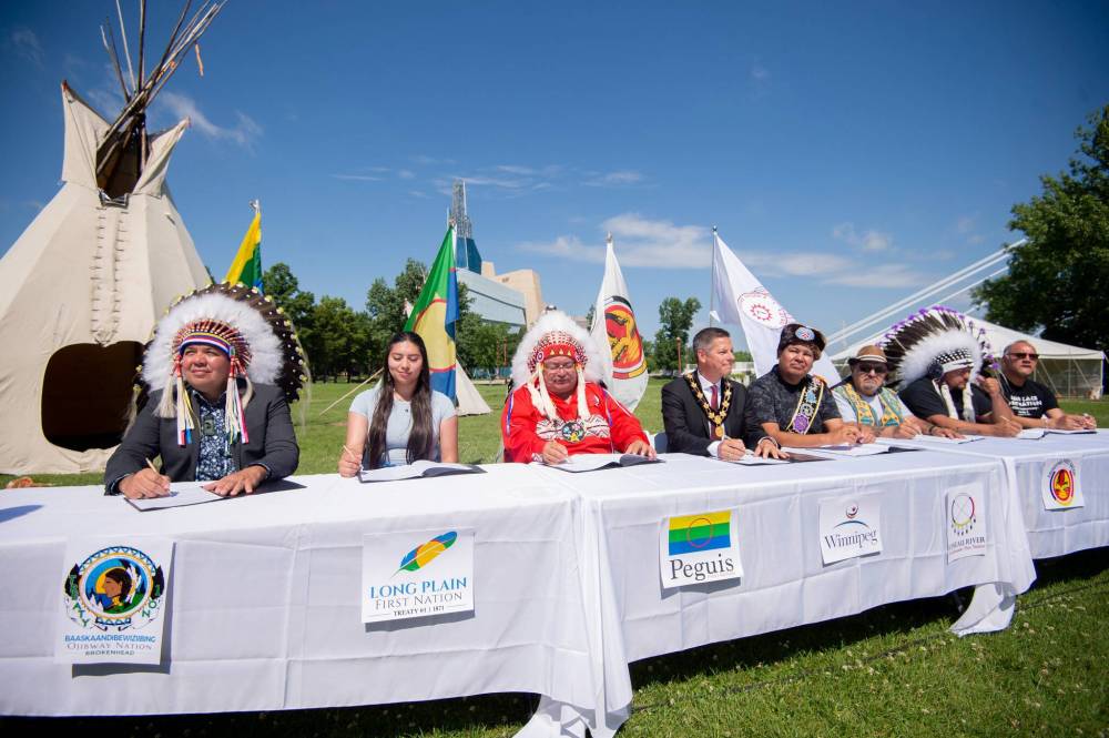 The agreement to establish an urban reserve at the former Kapyong barracks site in southwest Winnipeg is signed at The Forks Wednesday. Seven Treaty 1 nations are party to the deal. (Mike Sudoma / Winnipeg Free Press)
