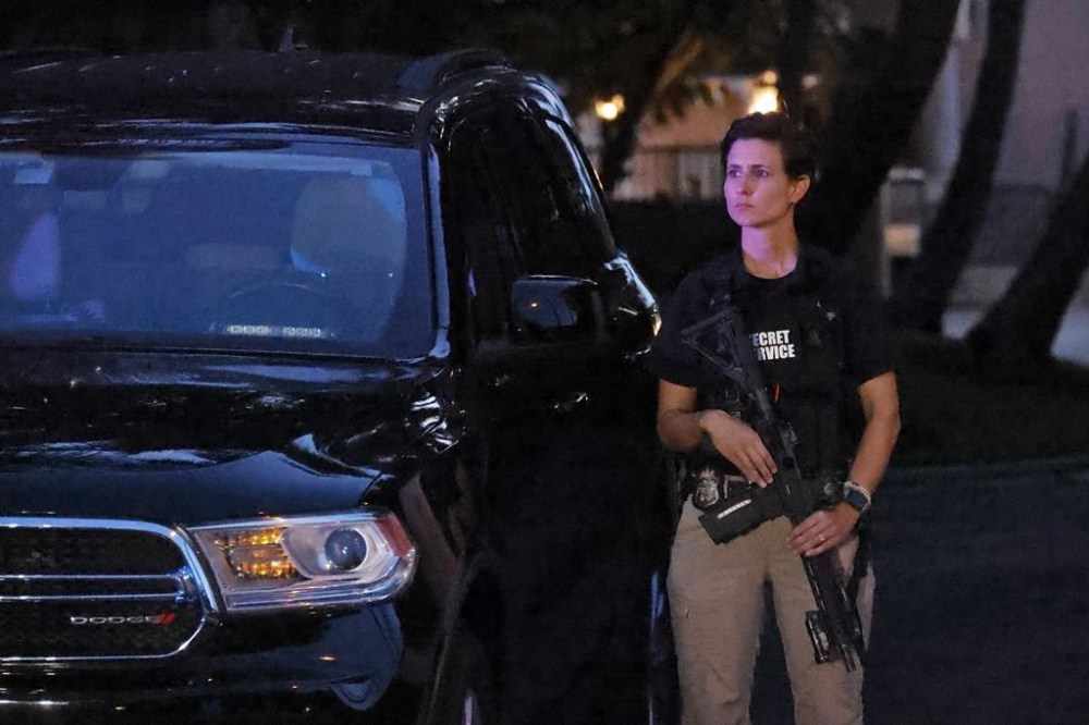 An armed Secret Service agent stands outside an entrance to former President Donald Trump's Mar-a-Lago estate, Monday, Aug. 8, 2022, in Palm Beach, Fla. Trump said in a lengthy statement that the FBI was conducting a search of his Mar-a-Lago estate and asserted that agents had broken open a safe. (AP Photo/Terry Renna)