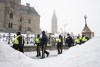 Police officers walk pass the Parliament buildings after a protest in Ottawa on Sunday, Feb. 20, 2022. The inquiry into Ottawa's unprecedented use of the Emergencies Act during protests in February will start its public hearings next month. The Public Order Emergency Commission announced today that it expects the hearings to run from Sept. 19 until Oct. 28 at Library and Archives Canada in downtown Ottawa. THE CANADIAN PRESS/Adrian Wyld