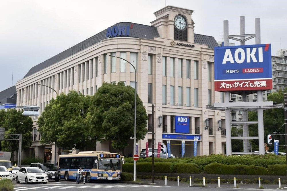 This photo shows the headquarters of Aoki Holdings Inc., a clothing company, in Yokohama, near Tokyo Wednesday, Aug. 17, 2022. A former Tokyo Olympic organizing committee board member and three people from the clothing company that was a surprise sponsor of the 2020 Games were arrested on bribery suspicions Wednesday. (Kyodo News via AP)