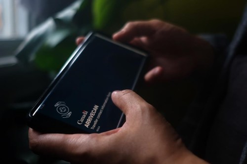 A person holds a smartphone set to the opening screen of the ArriveCan app in a photo illustration made in Toronto on June 29, 2022. The Justice Centre for Constitutional Freedoms has filed an action today in Federal Court challenging mandatory use of the ArriveCan app. THE CANADIAN PRESS/Giordano Ciampini