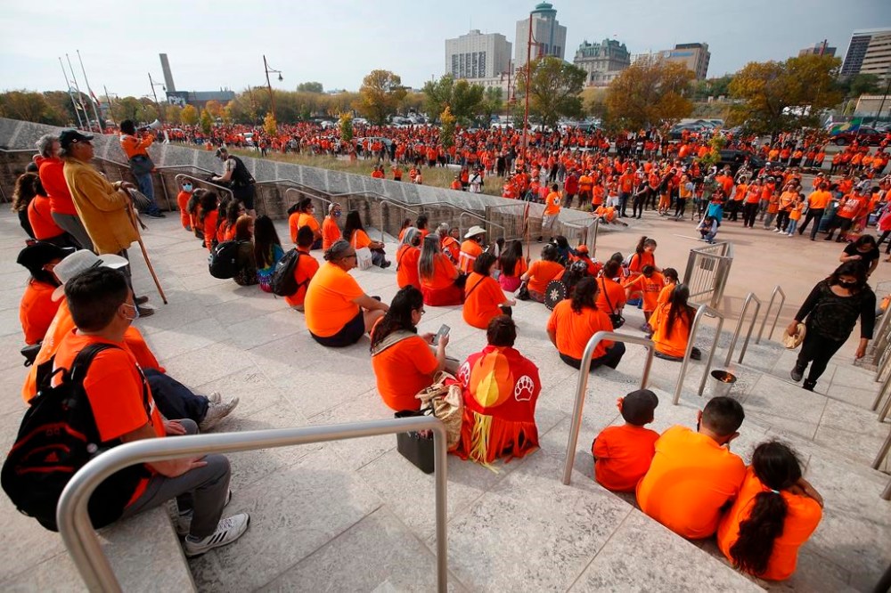 Residential School and Sixties Scoop survivors are honoured on the steps of the Canadian Museum for Human Rights in downtown Winnipeg, Thursday, Sept. 30, 2021. The Manitoba government is planning to make the National Day for Truth and Reconciliation an official statutory holiday, but says it's too late for the change to take effect this year.THE CANADIAN PRESS/John Woods