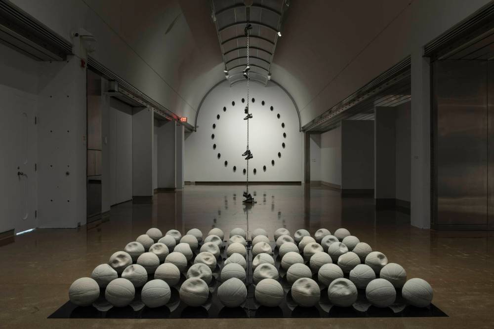 SUBMITTED
Esmaa Mohamoud’s Heavy Heavy (Hoop Dreams), features 60 white basketballs in various states of deflation arranged in a grid on black acrylic.