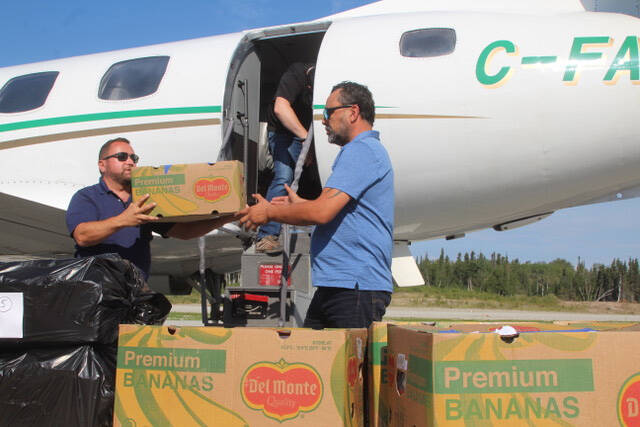 MAGGIE MACINTOSH / WINNIPEG FREE PRESS
Vince Barletta, CEO of Harvest Manitoba (left) and Jason Stevens, northern program officer for Food Banks Canada, unload food donations for St. Theresa Point First Nation from Winnipeg.