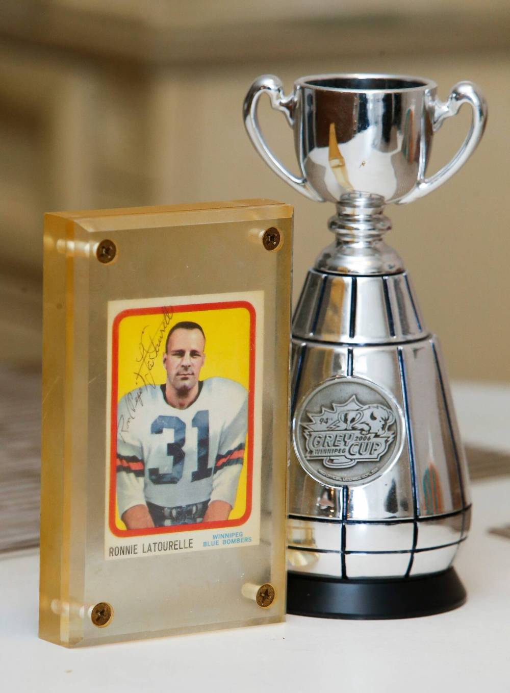 JOHN WOODS / WINNIPEG FREE PRESS Former Winnipeg Blue Bomber Ron (Pepe) Latourelle and one of the last surviving members of the 1960 team rookie card is photographed in his home in Winnipeg Tuesday, August 16, 2021. Latourelle won 4 Grey Cups and was inducted into the Manitoba Football and Blue Bomber Halls of Fame. Latourelle looks through photos of teammates and shows off a championship ring he received in 2007.