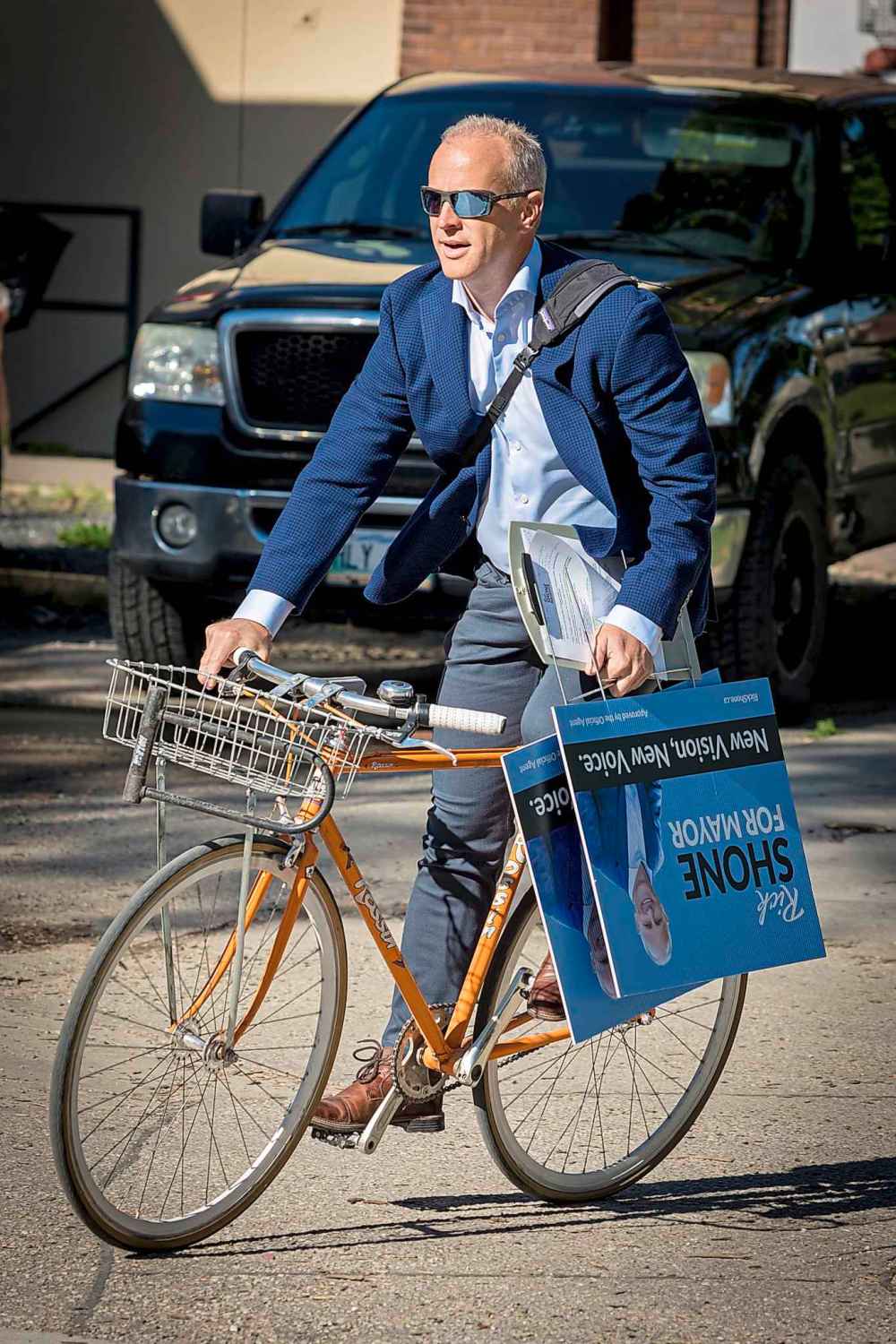 Kelly Morton photo
Mayoral candidate Rick Shone rides his bike while campaigning on Wednesday. The bike was stolen the same day.