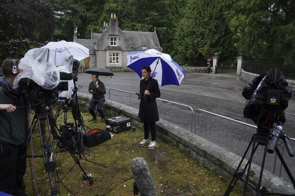 Media gather at the entrance to Balmoral in Scotland, where the Queen is under medical supervision, Thursday, Sept. 8, 2022. Buckingham Palace says Queen Elizabeth II has been placed under medical supervision because doctors are “concerned for Her Majesty’s health.” Members of the royal family traveled to Scotland to be with the 96-year-old monarch. The announcement comes a day after the queen canceled a virtual meeting of her Privy Council when doctors advised her to rest following a full day of events on Tuesday, when she formally asked Liz Truss to become prime minister. (Andrew Milligan/PA via AP)